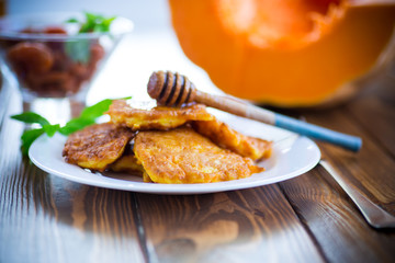 tasty fried sweet pumpkin pancakes with honey