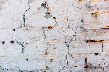 Texture of a concrete wall with cracks and scratches which can be used as a background