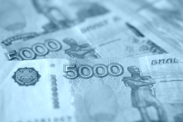 Russian banknotes of five thousand rubles close-up. Money background blue color toned