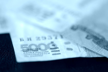 Russian banknotes of five thousand rubles close-up. Money background blue color toned