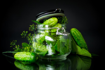 cucumbers and spices with herbs for canning in a jar