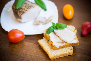 sandwich with home baked meat in a plate on a wooden