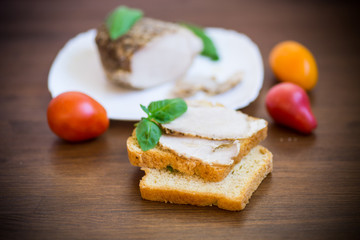 sandwich with home baked meat in a plate on a wooden