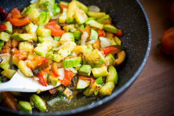 fried zucchini with red pepper, onions, tomatoes and other vegetables