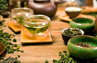 Chinese green oolong tieguanyin tea in glass cups on wooden background. Tea ceremony.
