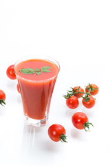 homemade tomato juice in a glass and fresh tomatoes