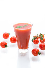 homemade tomato juice in a glass and fresh tomatoes