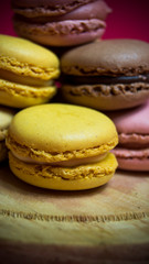 Colored macarons isolated on wooden dish, typical French dish