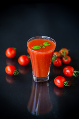 homemade tomato juice in a glass and fresh tomatoes