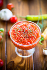 homemade hot adjika from tomatoes, hot and sweet peppers with spices