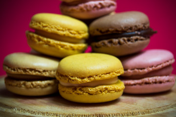 Fototapeta premium Colored macarons isolated on wooden dish, typical French dish