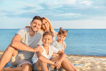 Portrait of happy family on sea beach