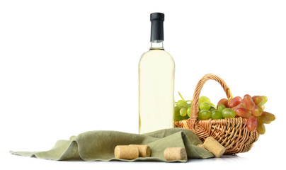 Bottle of wine and basket with grapes on white background