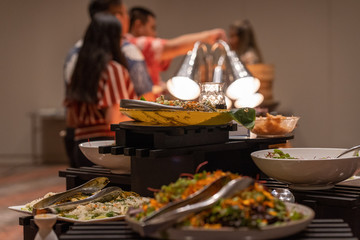 People eating from buffet