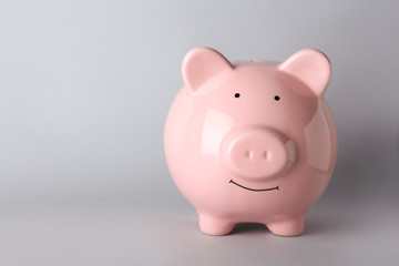 Piggy bank on grey background