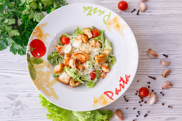 Caesar salad with seafood, the plate says pasta.