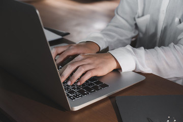 Young woman working on laptop late in evening