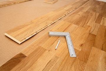 Parquetry, engineered click system oak wood flooring in a room that is being renovated