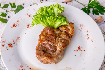 steak on a white plate