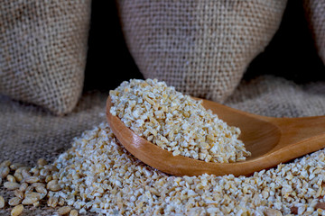 Groats on a wooden spoon.