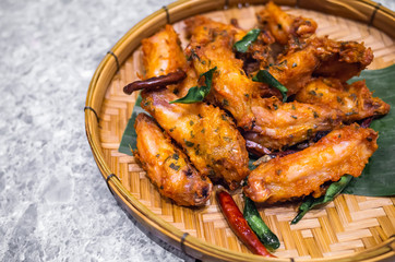 Asian food - Grilled Chicken Wings with herb and spicy serve on bamboo weave plate