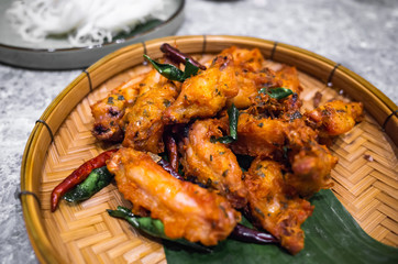 Asian food - Grilled Chicken Wings with herb and spicy serve on bamboo weave plate