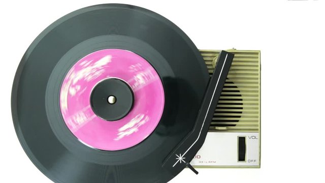 retro record player playing an old 45 record shot from above 
