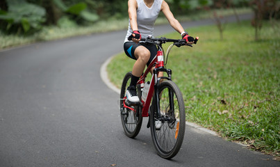 Fototapeta premium Woman riding bike in park