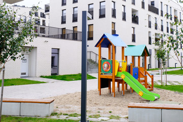 Fototapeta na wymiar Colorful Children Playground in a cozy courtyard of modern residential district.