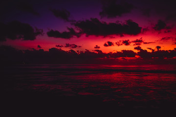 Fototapeta na wymiar Bright colorful sunset with clouds in Bali and ocean