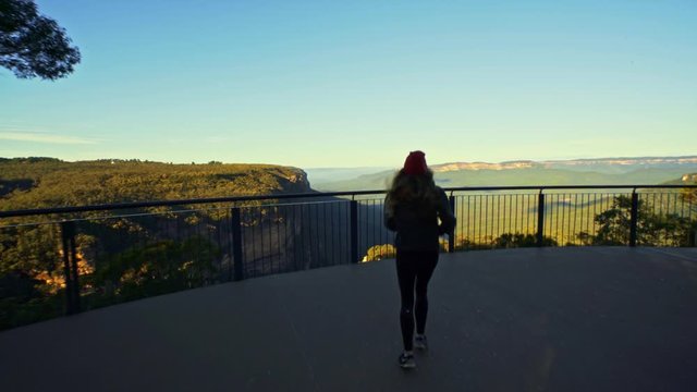 Female Tourist Running to Fence of Viewpoint of Blue Mountains National Park, Australia, Cinematic Pull Up Shot