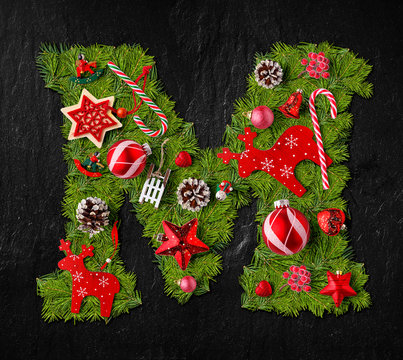 Letter M made of Christmas tree ornaments