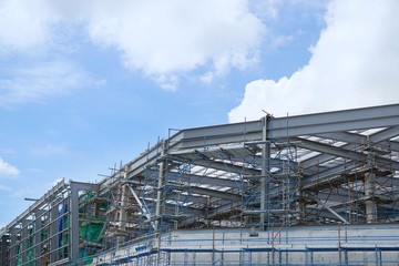 The structure of building with blue sky and clound as a background, Steel construction in large construction site, Space for text in template
