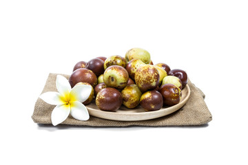 Chinese jujube on wood plate, isolated on white background