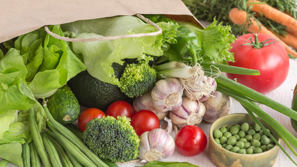 Healthy food in paper bag of different  vegetables on white background. Top view.