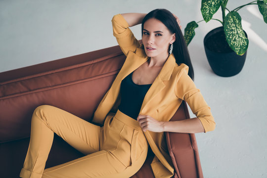 Top above high angle photo of elegant sweet fancy girl lady lie on brown leather couch want attract handsome millionaire man wearing stylish good looking clothes indoors