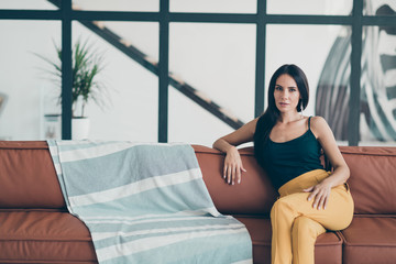 Portrait of her she nice-looking attractive glamorous lovely winsome groomed lady sitting on sofa in modern style interior glass open space apartment room flat house indoors