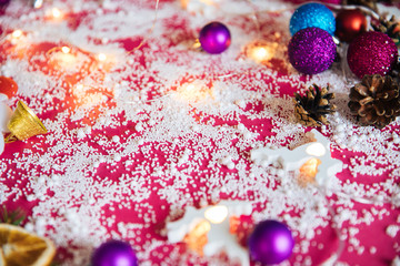 Fototapeta na wymiar Awesome Christmas background, pink Christmas background with a Christmas tree, toys, Christmas tree balls, snow, cones, decorations for a higher event for the New Year and Christmas, a cozy home atmos