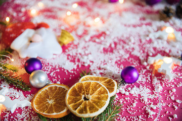 Awesome Christmas background, pink Christmas background with a Christmas tree, toys, Christmas tree balls, snow, cones, decorations for a higher event for the New Year and Christmas, a cozy home atmos