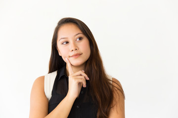 Pensive student girl touching face with finger. Young Latin woman in casual standing isolated over white background, looking at copy space away. Advertising concept