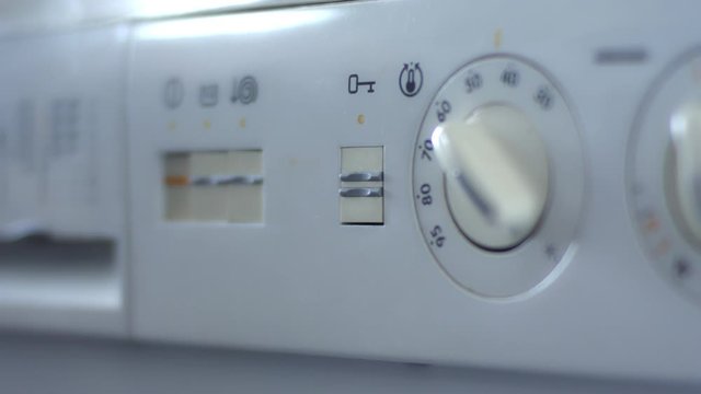 Old washing machine opening by pressing button close up
