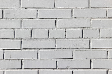 Texture of an old brick wall painted in white