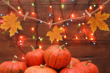 Pumpkins, string with yellow maple leaves  and colorful fairy lights. Welcome Autumn party...