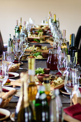 Сatering table with food and glass stemware at restaurant before party 