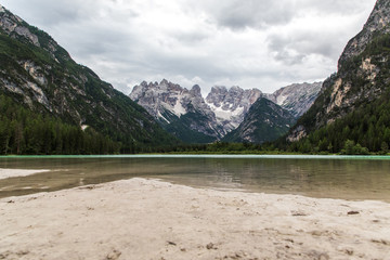 Naklejka na ściany i meble Dolomites, Italy - July, 2019: Big majestic mountains, view of Lake Landro Lago di Landro Cristallo group the Dolomites, Italy