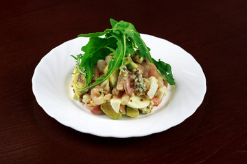 shrimp salad with egg and vegetables in a plate