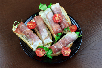 sandwich with bacon and herbs with cherry tomatoes	