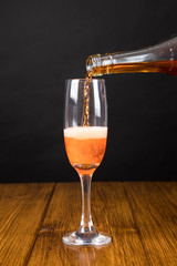 red champagne glass on a wooden background