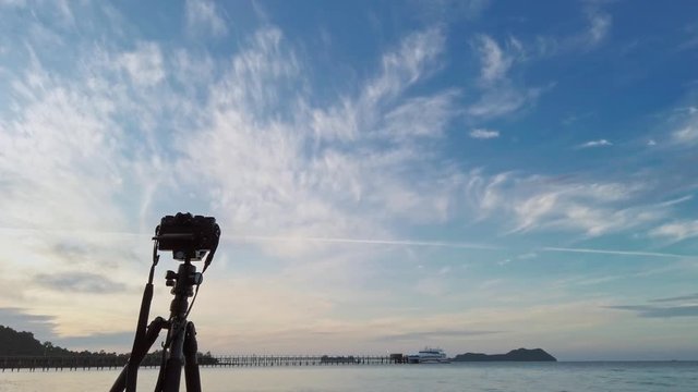 Camera on tripod with sunrise in the morning,Taking a picture of the landscape beach.