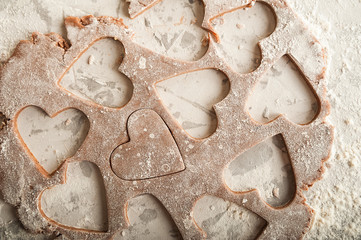 The texture of the dough closeup. Heart shaped gingerbread baking. Homemade cookies for Valentines Day and copy space. Keto baking.